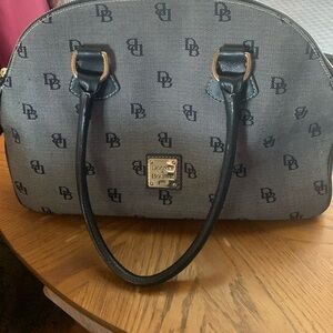 Dooney and Bourke in the classic DB pattern. Navy with pink inside